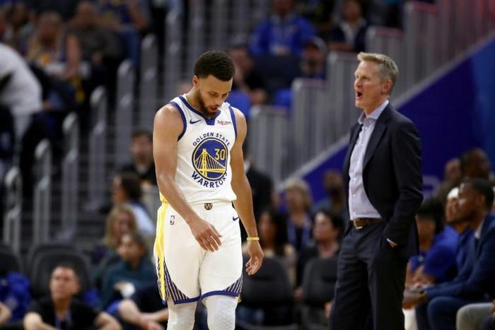Stephen Curry and head coach Steve Kerr react as the Warriors slump to a heavy season-opening defeat against the Los Angeles Clippers