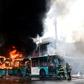 Chilean firefighters extinguish burning buses during clashes between protesters and the riot police in Santiago, on October 19, 2019.Chile's president declared a state of emergency in Santiago Friday night and gave the military responsibility for secur...
