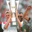 Then South Africa president Nelson Mandela (R) celebrates as captain Neil Tovey (L) holds the Africa Cup of Nations trophy after defeating Tunisia in the 1996 final