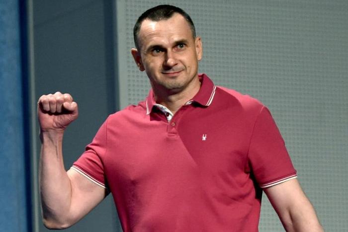 Freed Ukrainian film director Oleg Sentsov greets journalists on Tuesday