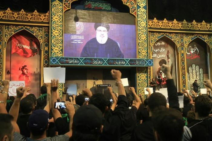 Hezbollah supporters gathered in the movement's southern Beirut stronghold to watch Nasrallah's speech on a big screen