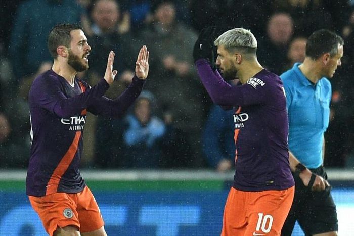 Manchester City survived a scare at Swansea to keep their quadruple bid alive