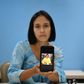 Venezuelan Mirian Gamarra, 39, displays a picture of her dead son Luis Alfredo Ariza, 21, on her mobile phone -- she says he was gunned down by special police for no reason