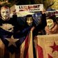 Demonstrators wear Guy Fawkes masks, hold Catalan pro-independence "Estelada" flags and placards reading "Freedom for Political Prisoners" during a "Million Mask March" organised by Anonymous and other movements this week