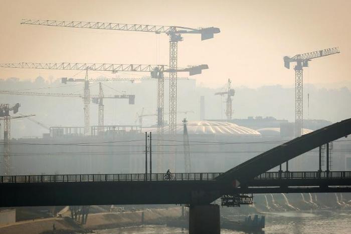 A man rides a bicycle on one of Belgrade's bridges on October 27, 2019. Serbian health authorities warned on October 27, 2019, against "very high" air pollution in Belgrade and several other cities in the country, a situation that has persisted for sev...