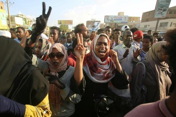 Sudanese demonstrators march during a protest in Khartoum urging the country's new authorities to dissolve the former ruling party of ousted Islamist leader Omar al-Bashir