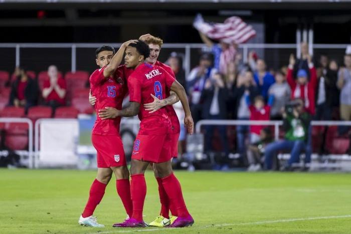 Weston Mckennie of the United States celebrates with Cristian Roldan and Josh Sargent in the first half of a 7-0 victory over Cuba in the 2019 CONCACAF Nations League in Washington