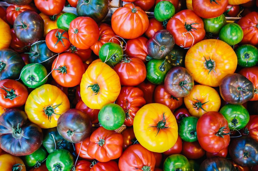 Directly above view of multicolored tomatoes on the market stall at farmer's market