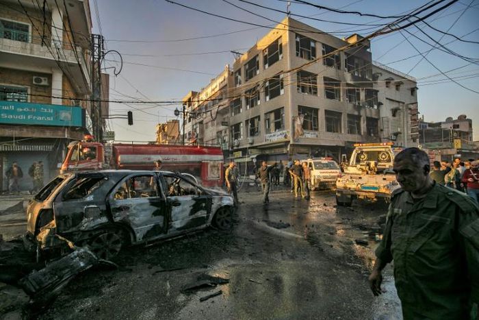 Simultanaous blasts near a busy market and a school in Syria's Kurdish-majority city of Qamishli killed six people and wounded 22