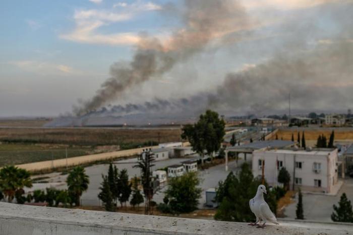 Smoke rises from the Syrian town of Tal Abyad, in a picture taken from the Turkish side of the border on October 10, 2019, on the second day of Turkey's military operation against Kurdish forces