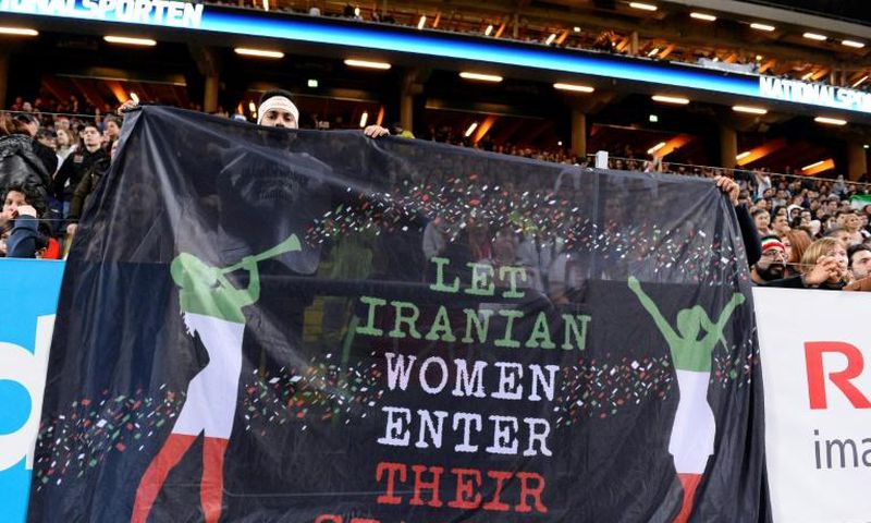 Supporters hold a banner calling for Iranian women to be allowed to enter football stadiums, during a match between Sweden and Iran near Stockholm in March 2015