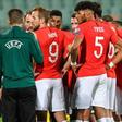 England players speak with the officials during a stop in play due to racist abuse