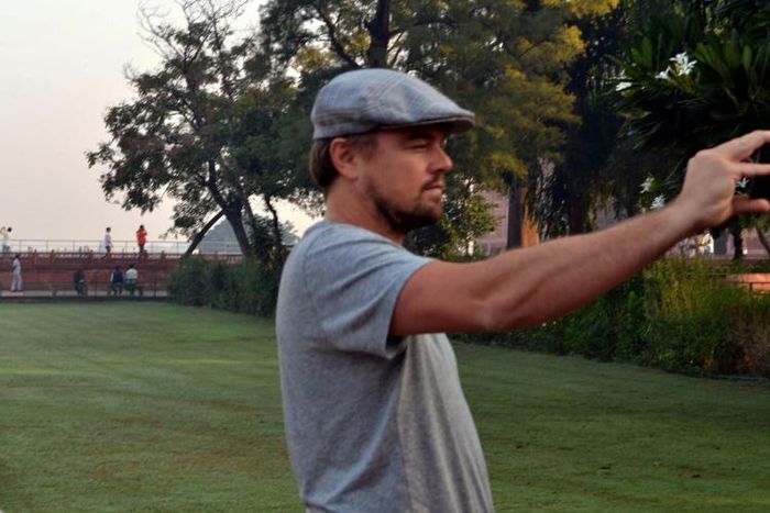 Hollywood star Leonardo DiCaprio takes a photograph in the gardens of the Taj Mahal during a visit to India in 2015