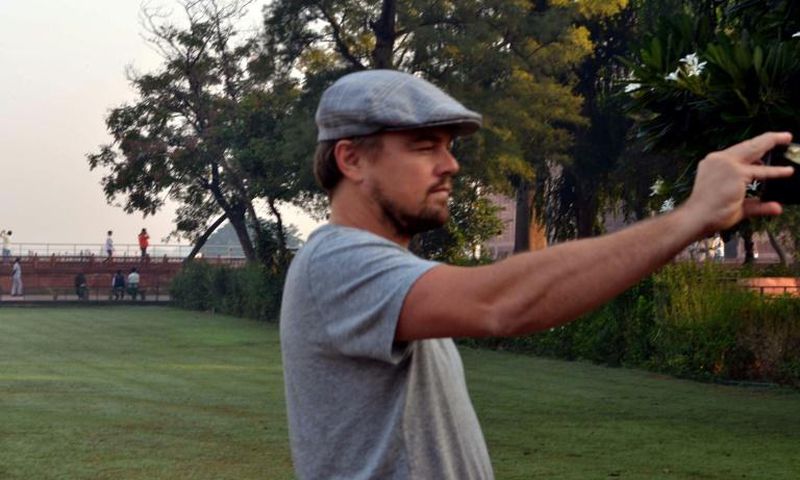 Hollywood star Leonardo DiCaprio takes a photograph in the gardens of the Taj Mahal during a visit to India in 2015