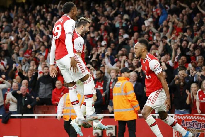 Top Gunner: Pierre-Emerick Aubameyang (right) celebrates scoring the winner in a thrilling 3-2 victory over Aston Villa