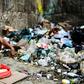 A man waits to get some food at a garbage dump in Las Minas de Baruta neighborhood, Caracas, Venezuela, on March 14, 2019