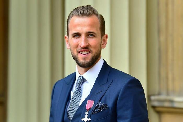 Harry Kane poses with his MBE award at Buckingham Palace