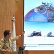 Saudi defence ministry spokesman Turki bin Saleh al-Malki shows off pictures as he alleges that strikes on the country's oil infrastructure came from the north and were 'unquestionably' sponsored by Iran
