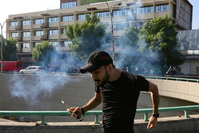 Iraqi security forces fired tear gas to fore protesters away from Baghdad's Green Zone on Saturday morning