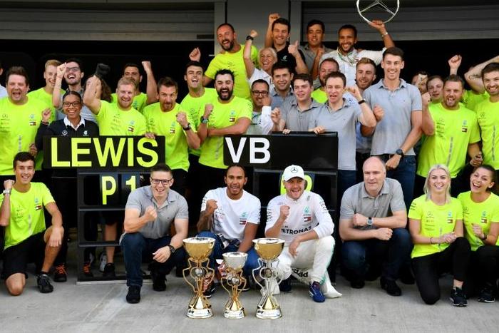 Lewis Hamilton and Valtteri Bottas celebrate with the Mercedes team after the Formula One Russian Grand Prix in Sochi