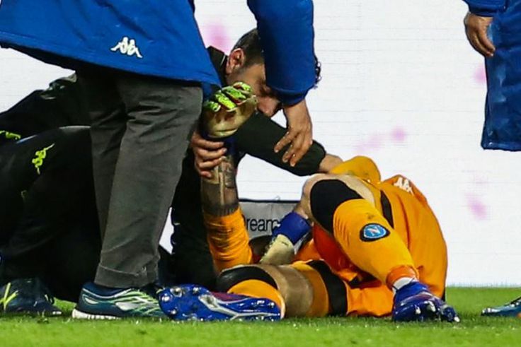 A medic tends to Napoli's Colombian goalkeeper David Ospina who lost consciousness after sustaining a head injury