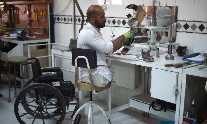 An Afghan orthopaedic technician makes artificial limbs in a workshop at the International Committee of the Red Cross hospital for war victims and the disabled in Kabul