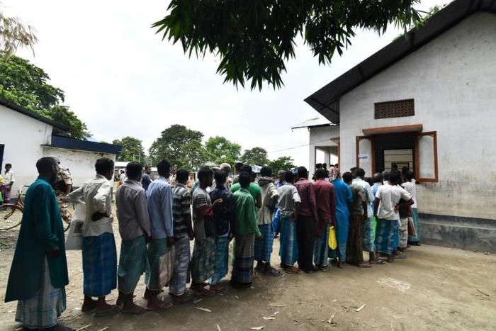 Assam residents stand in line to check if their names are included on the final list of the National Register of Citizens