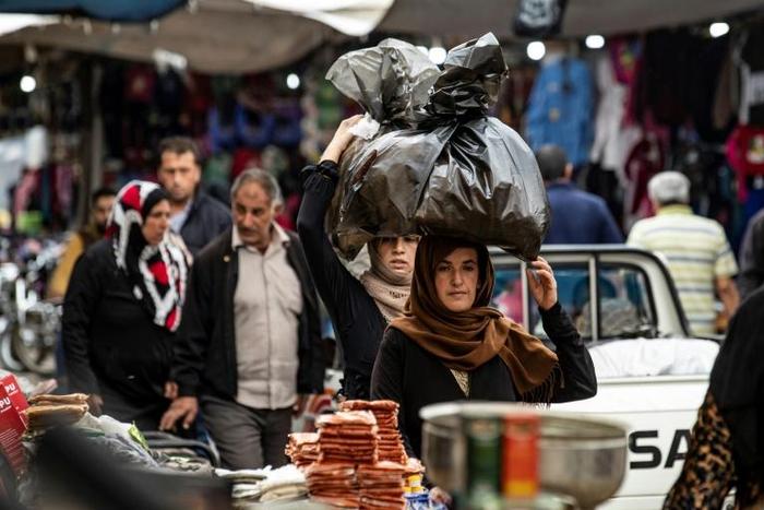 Residents of the Kurdish-majority Syrian city of Qamishli have been spared a Turkish invasion, but many fear the return of the Syrian regime