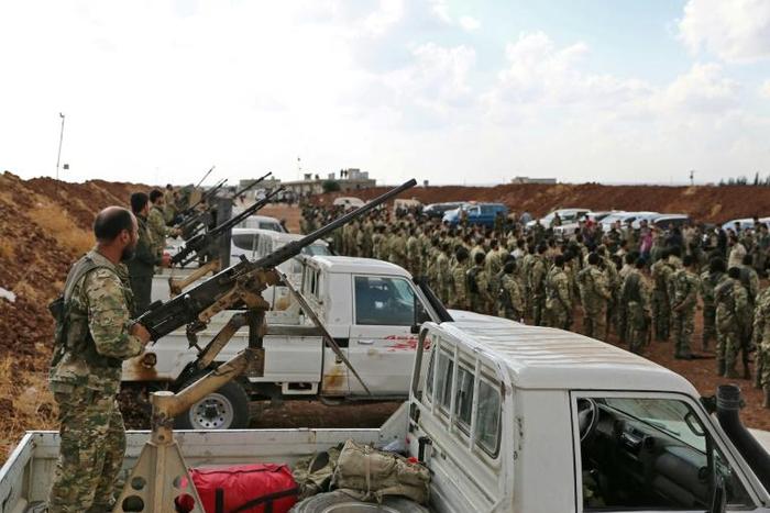 Turkish-backed Syrian rebel fighters gather near the Syrian-Turkish border as Ankara threatened an offensive against Kurdish militias it considers terrorists
