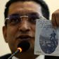 Lawyer Ali Sabry holds a document that is purportedly the cancelled US passport of Sri Lanka presidential candidate Gotabhaya Rajapakse