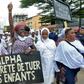 Protestors held up placards reading 'Children shot, Future lost,' and 'Alpha, stop killing our children'