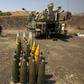 Artillery shells are lined up beside an Israeli self-propelled artillery gun near the Lebanese border