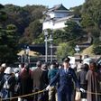 Police officers stand guard around Japan's Imperial Palace ahead of Sunday's parade