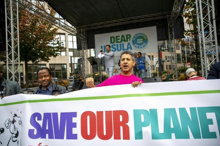 Protestors hold a banner during a demonstration for the climate called 'Act Now or Never' to raise awareness for climate change, organised by 'Rise for Climate Belgium', in on September 22, 2019 in Brussels.