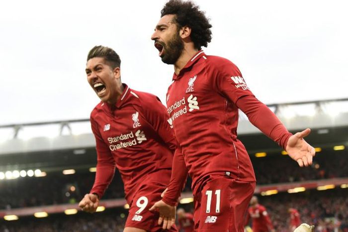 Liverpool's Mohamed Salah (right) and Roberto Firmino (left) celebrate a huge win for their title ambitions