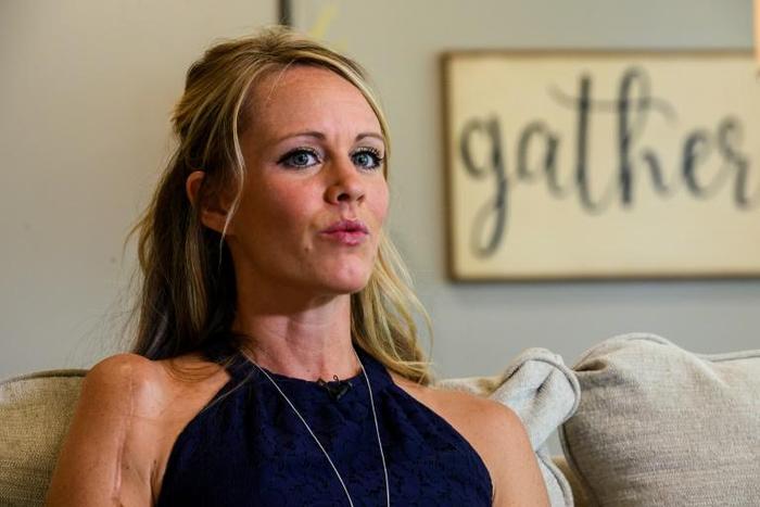 Kacey Ruegsegger Johnson, a survivor of the Columbine High school shooting in 1999, speaks with reporters from AFP in her house in Raleigh, North Carolina