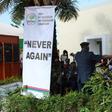 This picture shows a banner reading "Never Again" is seen as a police band performs during the Truth and Reconciliation and Reparation Commission, at the Dune's Resort, in Kotu, near Bajul, on October 15, 2018