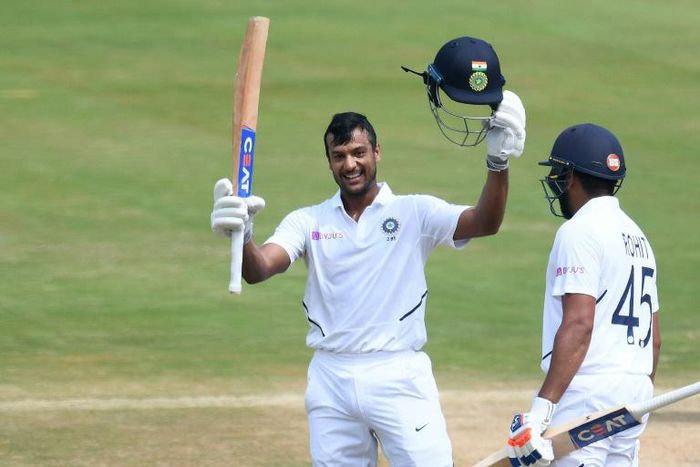 Mayank Agarwal raises his bat after reaching 100