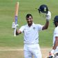 Mayank Agarwal raises his bat after reaching 100