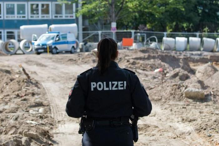 A police officer secures access to the site in Hanover's Zoo district after the bomb's discovery which forced thousands of residents to leave their homes while it was defused