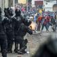 Demonstrators clash with riot police as thousands march against Ecuadorean President Lenin Moreno's decision to slash fuel subsidies, in Quito on October 9, 2019