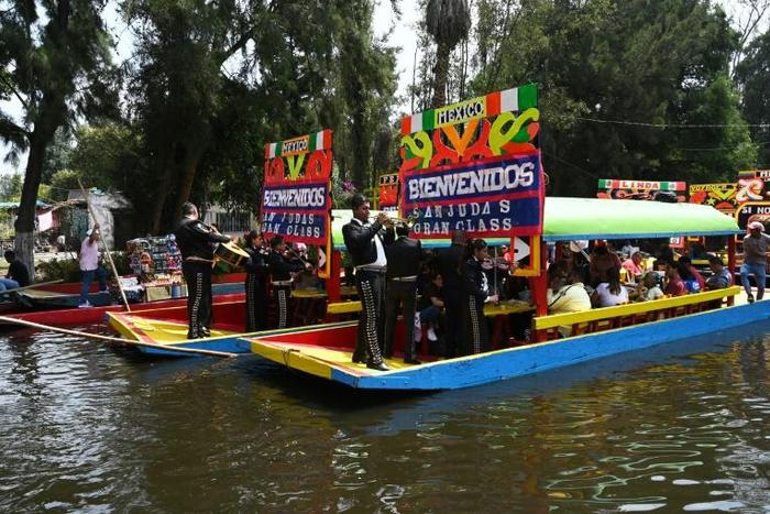Mariachis onboard "Trajineras" offer their music to visitors in Mexico City's Xochimilco in early October