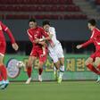 South Korea's Hwang Ui-jo and North Korea's Ri Yong Jik fight for the ball during the World Cup 2022 Qualifying match in Pyongyang
