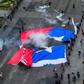 Demonstrators in Santiago carried a torn Chilean flag on October 25, 2019, as sometimes violent protests over both political and economic demands showed little sign of abating