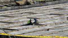 The particles are understood to be the product of uranium which has been mined and undergone initial processing, but not enriched; A picture taken on November 10, 2019, shows workers on the construction site of a second reactor in the Bushehr nuclear p...