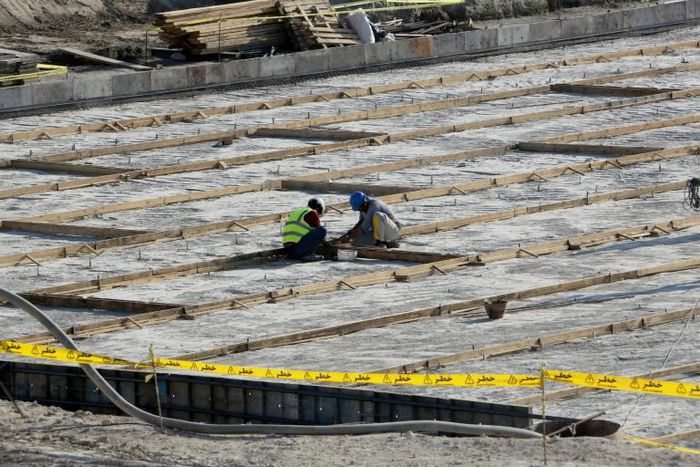 The particles are understood to be the product of uranium which has been mined and undergone initial processing, but not enriched; A picture taken on November 10, 2019, shows workers on the construction site of a second reactor in the Bushehr nuclear p...