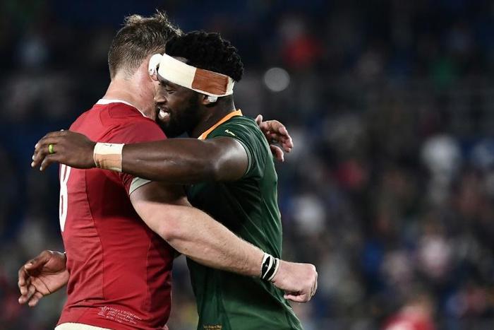 Captain Siya Kolisi (R) hugs teammate Duane Vermeulen, wearing a Wales shirt, after a 19-16 World Cup semi-final victory last Sunday