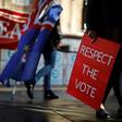 Pro-Brexit and Pro-EU protesters occupy the footpaths beside the Houses of Parliament in Westminster, central London