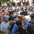 Algerian police officers confront protesters during an anti-government demonstration in the capital Algiers