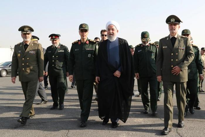 A handout picture provided by the Iranian presidency on Sunday shows President Hassan Rouhani (C) with top military officials
